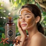 A serene image of a young woman gently applying a soothing clove oil mask to her glowing, radiant skin. The mask, infused withclove oil, has a rich, golden hue. Intricate patterns adorn the bottle of clove oil, emphasizing its exotic, spicy aroma. The background is a tranquil, lush garden with a gentle breeze blowing soft petals in the air. A sense of rejuvenation and natural beauty surrounds the scene.